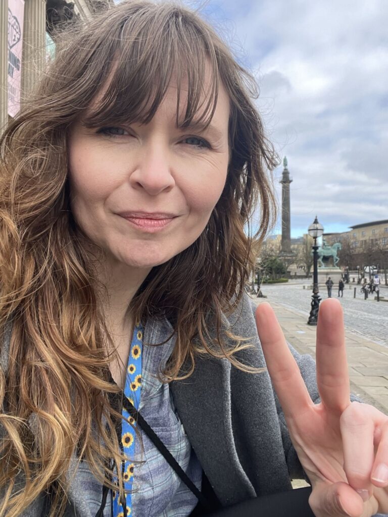 Jessica Friday Flashing a Peace Sign in front of St Georges Hall Liverpool